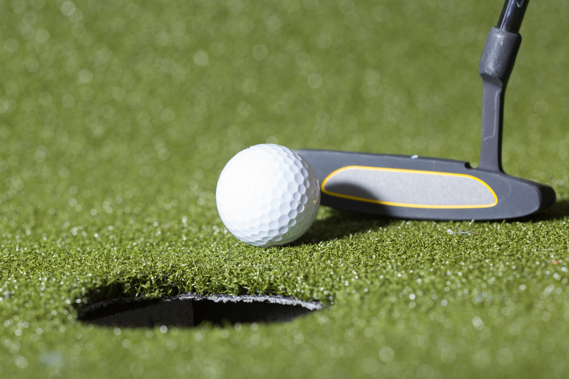 Golf concept image. Close up shot of putting.